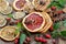 Christmas background. dried lemon, orange, grapefruit, anise stars, mint leaves, cinnamon, and rose hips on a wooden table. spices