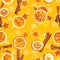 Christmas background of dried oranges, peel in the shape of a star and with cinnamon. Seamless background
