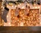 Christmas background. Empty wooden table on tthe background of a christmas fireplace with firewood, santa socks, golden bokeh,