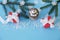 Christmas background with fir branches, bell and snowflakes and gift red box with white ribbon on the blue background. Christmas.