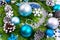 Christmas background with fir branches, silver beads, turquoise