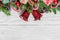 Christmas background with fir tree, christmas bells, candy, gift boxes, berries and pine cones on white wooden table