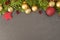 Christmas background with firtree, baubles and stars on slate