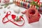 Christmas background with gift boxes, ribbon, twine, paper rolls, knitted hearts and Christmas ornament