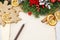 Christmas background with gingerbread cookies, fir wreath, dried fruits and vintage sheets of paper