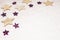 Christmas background, with golds and purple glitter stars and sn