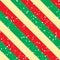 Christmas background with green, red and yellow diagonal stripes and snow. Vector seamless pattern