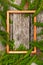 Christmas background for greeting card. wooden frame and Fir branches on wooden background.