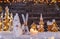 Christmas background with illuminated wooden village and snowman