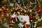 Christmas background of old fashioned tree with an eclectic variety of ornaments including santa and pearl garland and a gift enve