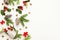 Christmas background with pine cones, branches of holly with red berries and fir tree on white. Winter festive nature concept.