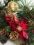 Christmas background with pine tree branch, pine cones, red flower in snow