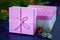 Christmas background. Pink boxes on white wooden background fir-