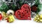 Christmas background with a red heart ornament