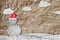 Christmas Background, Snowman wearing red Santa hat in winter with white clouds snow, paper cut made of crumpled paper