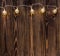 Christmas background with string lights. vintage garland on wooden planks.
