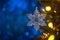 Christmas and background.Toy in the form of a transparent star on a Christmas tree, background for a card, dark blue bokeh