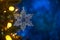 Christmas and background.Toy in the form of a transparent star on a Christmas tree, background for a card, dark blue bokeh