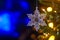 Christmas and background.Toy in the form of a transparent star on a Christmas tree, background for a card, dark blue bokeh