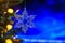 Christmas and background.Toy in the form of a transparent star on a Christmas tree, background for a card, dark blue bokeh