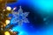 Christmas and background.Toy in the form of a transparent star on a Christmas tree, background for a card, dark blue bokeh