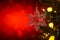 Christmas and background.Toy in the form of a transparent star on a Christmas tree, background for a card, dark red bokeh