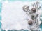 Christmas background with vintage glass bauble , frozen branches and cones on snow with snowfall, top view