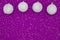 Christmas background with white ball ornaments on purple sparkles felt