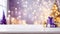Christmas background with white wood table, christmas gifts and blurred christmas tree lights in the background