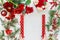 Christmas background with women hands holding wrapping paper. Various Christmas decoration: fir, Christmas flowers, pine cone and