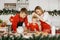 Christmas bakery. Family together making gingerbread in festive kitchen, father and son getting ready to cutt cookies of