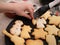 Christmas bakery: Little Girl painting cookie dough with sugar glazing