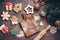 Christmas baking background. A variety of ginger glazed gingerbread, a pine branch and a garland on a dark rustic background. Top