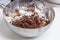 Christmas baking with raw chocolate dough in bowl and whisk. Holiday food concept, homemade child cookies and gingerbread. Close