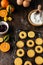Christmas baking, traditional linzer cookies with orange and berry jam on wooden table