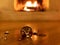 Christmas ball broken, blur burning fireplace background