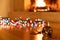 Christmas ball broken, colorful lights glowing, blur burning fireplace background