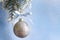 Christmas ball on fir branches and snowy blue background