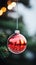 Christmas ball hanging on a christmas tree with bokeh background