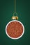 Christmas ball is made from rooibos tea on green background.