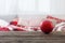 Christmas ball on old wooden table on background sofa with pillows and plaids