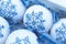 Christmas balls decorated with blue snowflakes embroidered with a cross