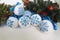 Christmas balls decorated with blue snowflakes embroidered with a cross