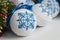 Christmas balls decorated with blue snowflakes embroidered with a cross