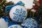 Christmas balls decorated with blue snowflakes embroidered with a cross