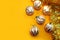 Christmas balls with decorations on a bright yellow background.