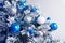 Christmas balls on fir tree. Blue and white. New Year holidays and Christmastime celebration