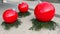 Christmas balls, x-mas balls, normally small balls for tree in bright red with fir green on townhouse square in Ratingen, Germany