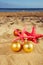 Christmas balls with starfish on beach