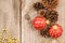 Christmas baubles, golden beads and pine cones top view